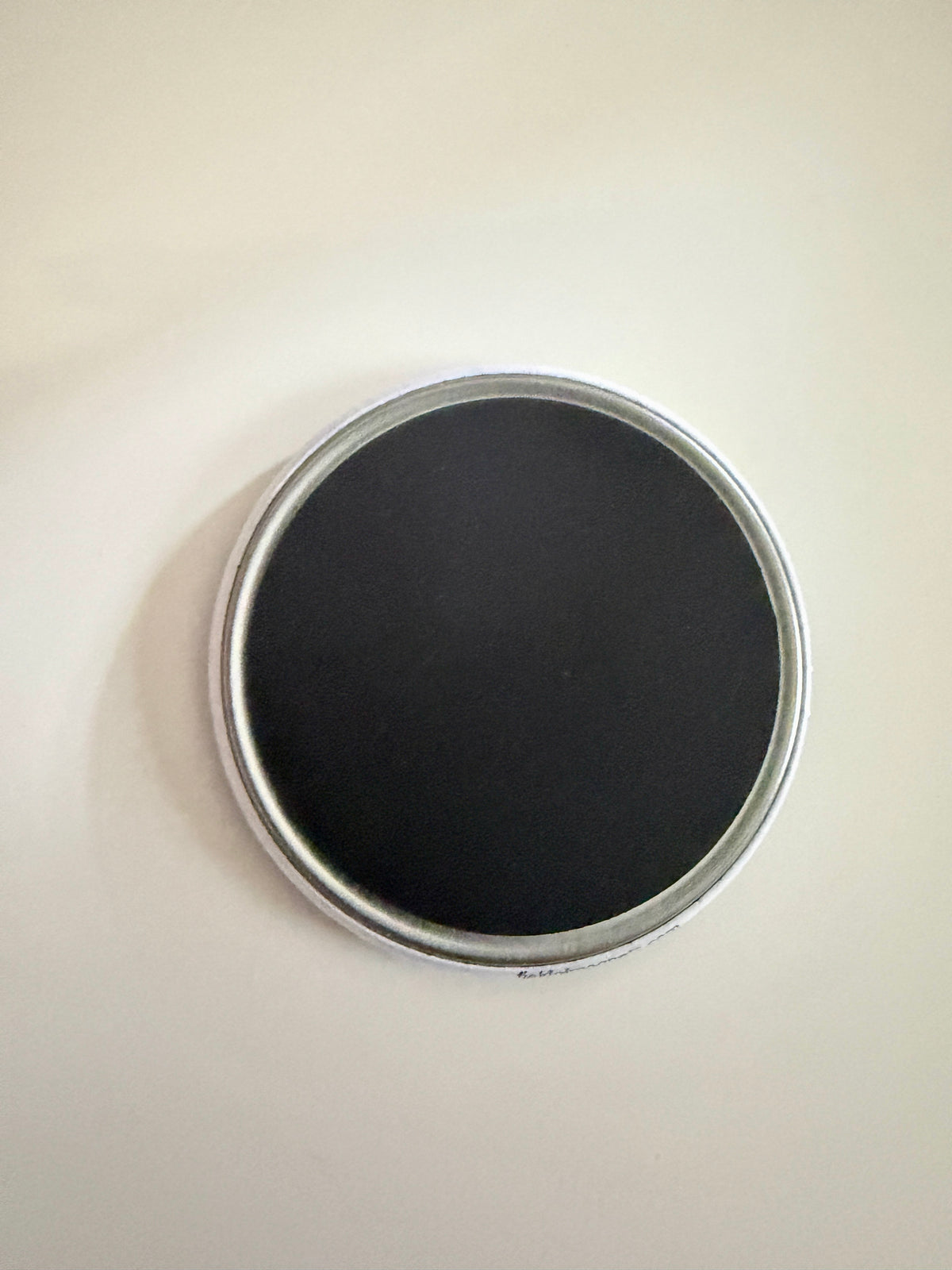 Back view of custom 2.25" round magnet showing strong magnet backing – Field of Magnets