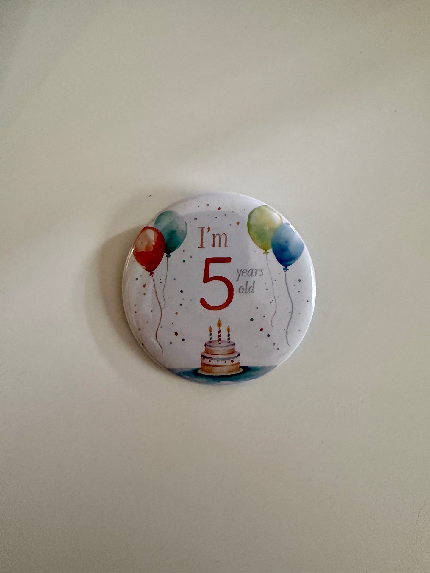 Back view of custom 2.25" round pin showing sturdy metal clasp – Field of Magnets